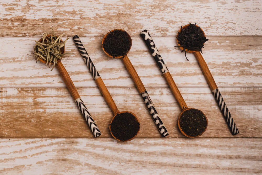 Tea samples on wooden spoons with animal print